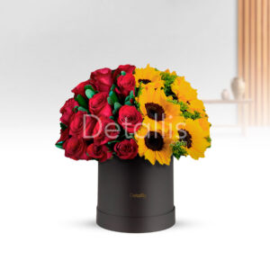 Un arreglo en caja con rosas y girasoles es una composición floral vibrante y alegre que combina la elegancia de las rosas con la energía y calidez de los girasoles. Presentado en una caja decorativa, es ideal para regalar en ocasiones especiales y transmitir sentimientos de amor, gratitud o alegría.
